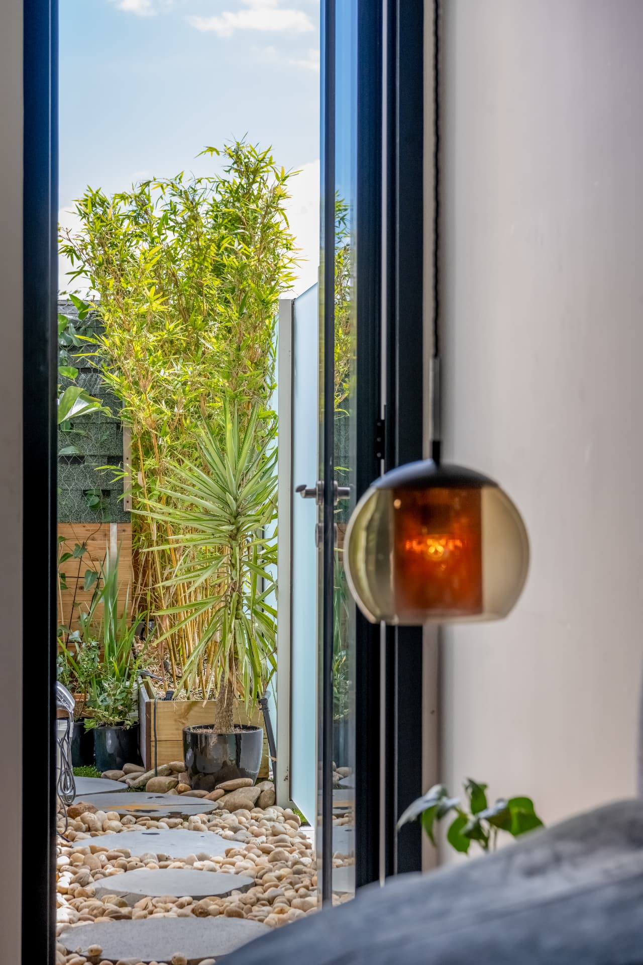 Bedroom doors opening to a private planted courtyard